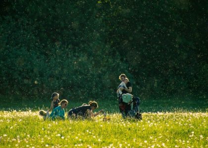 a group of people in a field with a dog